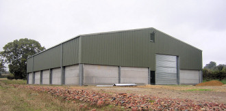 Steel framed grain store with concrete wall panels.