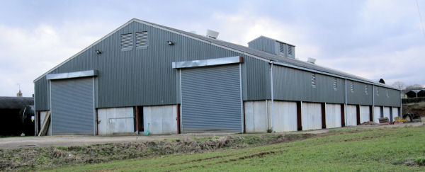 Steel framed grain store with concrete floor.